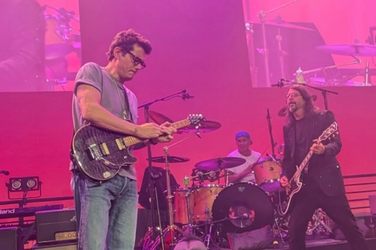 John Mayer performing with Dave Grohl at Soundstage of Hope while playing a Music Man Axis-style guitar during a Van Halen cover