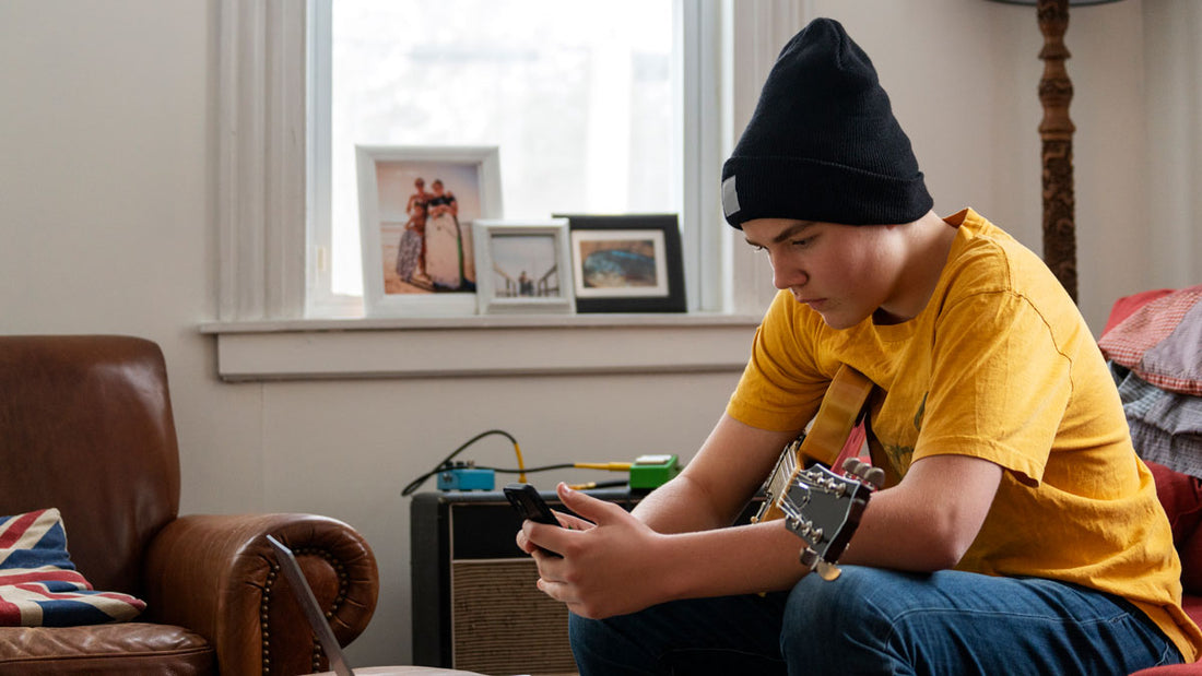 A guitarist performing on camera for a social media clip
